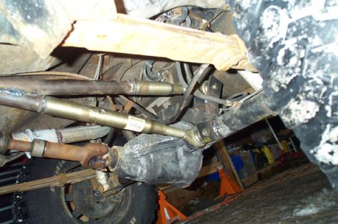 1991 Ford Bronco - Close-up of the undercarriage shows suspension and drive components, with a label visible on one of the rods.