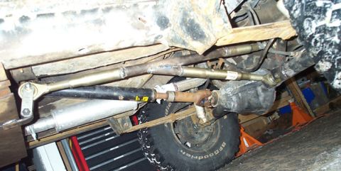 1991 Ford Bronco - Undercarriage view of a vehicle's suspension and drivetrain components.