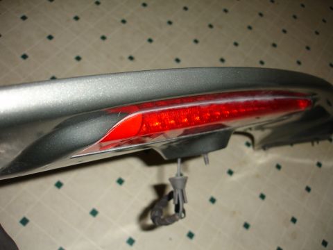 1993 Ford Taurus - Close-up of a car's rear spoiler with integrated LED brake light.