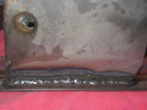 1991 Ford Bronco - Close-up of a metal part showing a weld seam and a circular hole.