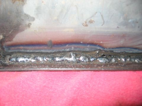 1991 Ford Bronco - This image shows a close-up view of a metal seam that has been welded, with visible weld beads and some discoloration from heat.