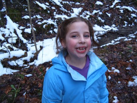 1993 Ford Bronco - A young girl smiles while standing outdoors in a snowy environment.