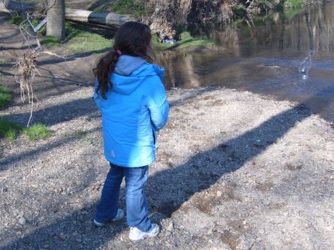 1993 Ford Bronco - A young girl stands on a gravelly bank looking at a flowing stream.