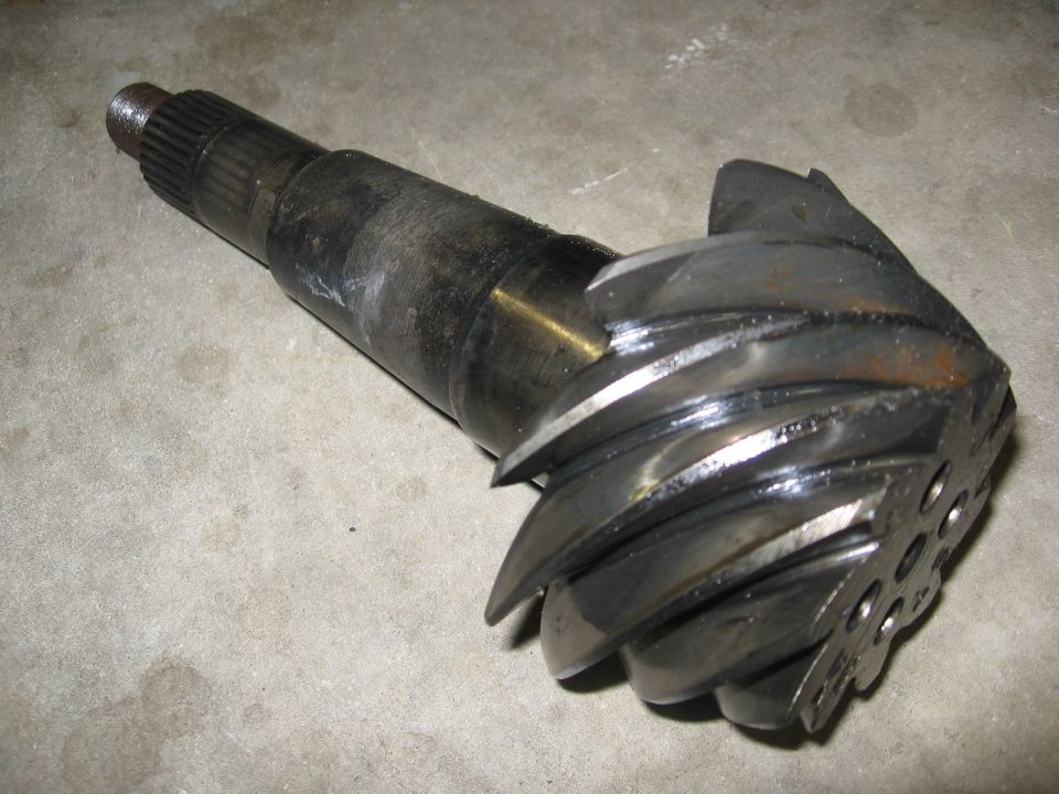 Differential pinion gear with splines on one end and spiral cut teeth on the other