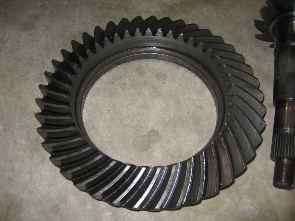 Ring gear and pinion shaft with splines, black metal, close-up view