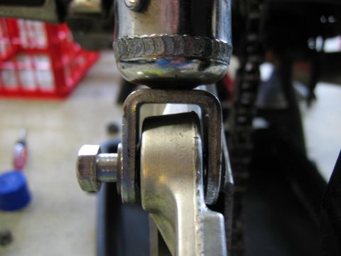 1985 Ford LTD Crown Victoria - Detail of a bicycle's chain and a metal bracket assembly.