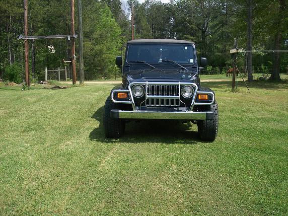 Black Jeep Wrangler front view on a country lawn