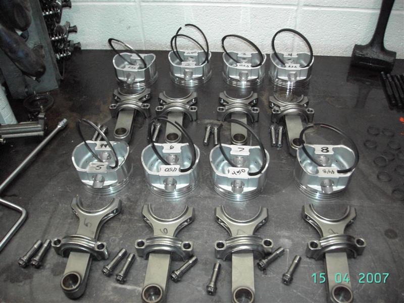 Assembling the new pistons to the rods.