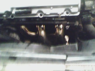 1993 Ford Probe - Close-up view of an engine manifold with exhaust pipes, showing the Supermotors.net logo.