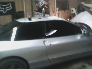 1993 Ford Probe - Side view of a silver coupe with tinted windows, showing a Supermotors.net logo in the lower right corner.