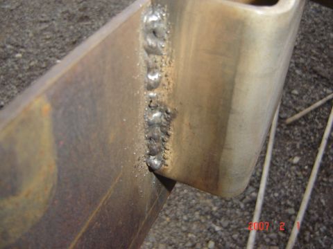 1993 Ford Bronco - A close-up shows a metal frame with a visible weld bead and some surface rust.