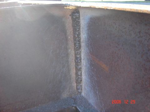 1993 Ford Bronco - A close-up view shows a prominent welded seam on the interior of a metal structure, with visible scratches and some surface discoloration.