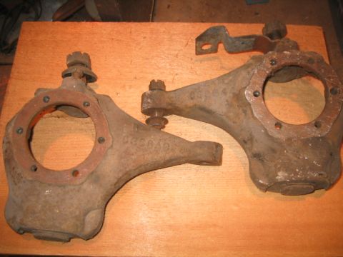 1973 Ford F-100 - Rusty steering knuckles, possibly for a Ford F-100, shown on a wooden workbench.