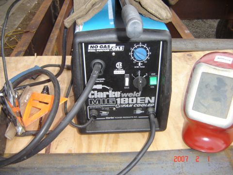 1993 Ford Bronco - A Clarke weld MIG 180EN welding machine is shown with a welding mask and gloves nearby.