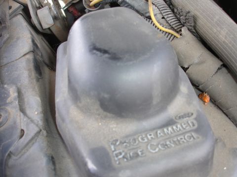 1993 Ford Taurus - Close-up of an engine component with visible text indicating "PROGRAMMED Ride Control" and surrounding wiring.
