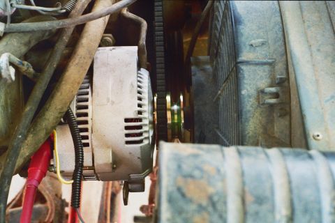 1978 Ford Bronco - Close-up view of an alternator and radiator in a vehicle's engine compartment.