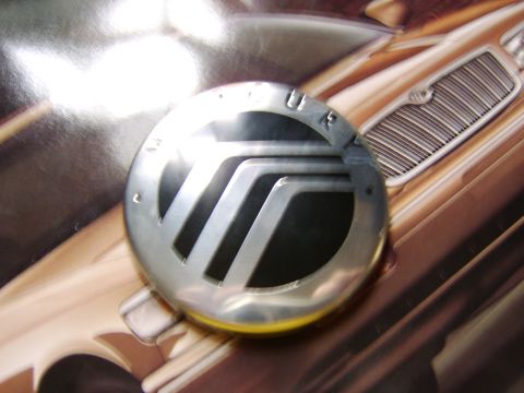 1996 Mercury Grand Marquis - A Mercury emblem is shown on a car's grille, possibly from a brochure or advertisement.