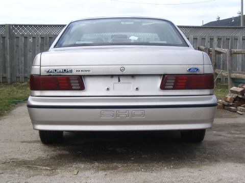 1993 Ford Taurus - The rear of a silver Ford Taurus SHO is shown, its distinctive badging and taillights.