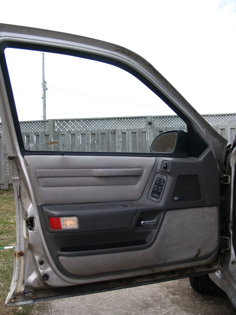 1993 Ford Taurus driver's side door interior showing panel, window controls, and handle