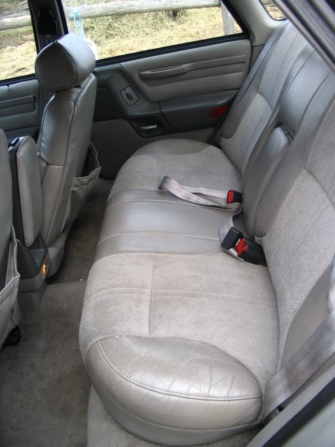 1993 Ford Taurus - Rear interior of a 1993 Ford Taurus, showing the seats and door panel.