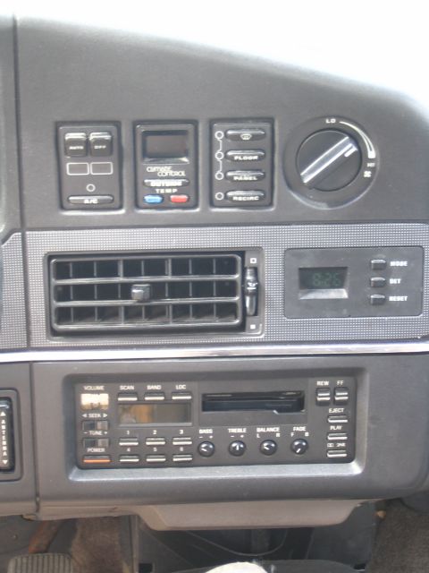 1993 Ford Taurus - Close-up of a car's dashboard showing the climate control panel and audio system.