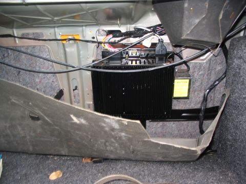 1993 Ford Taurus - The trunk interior shows wiring and an amplifier, with no clear year identification.