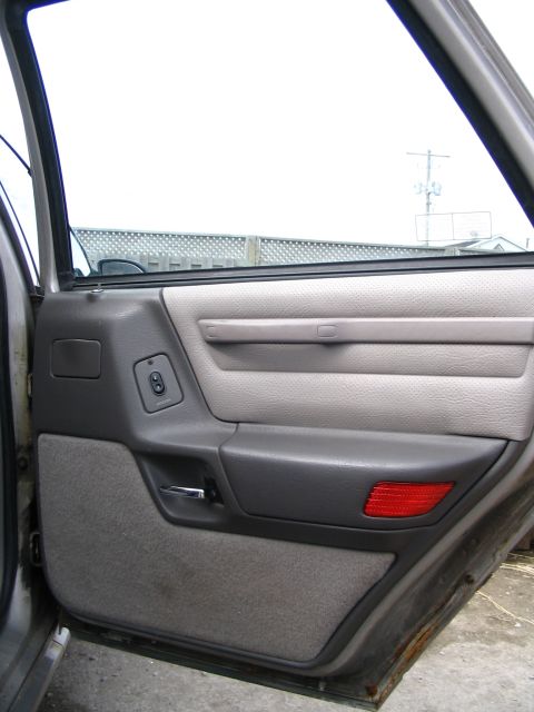 1993 Ford Taurus - Interior view of a 1993 Ford Taurus door panel, gray fabric and plastic trim.