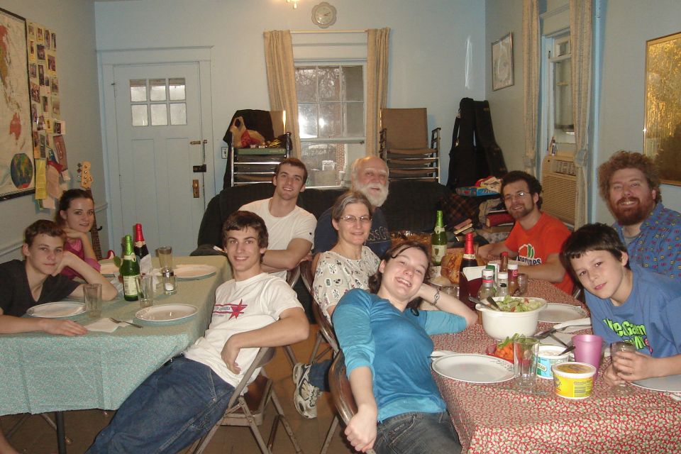 Group of people seated around tables sharing a meal indoors