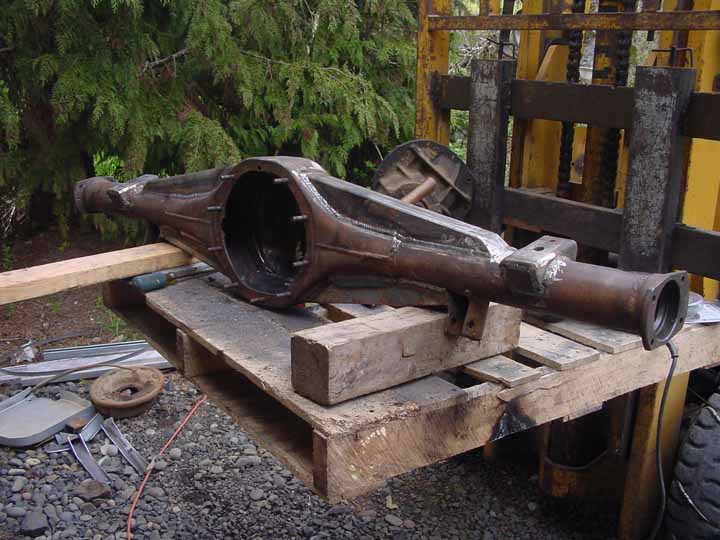 Rear axle housing on wooden pallet, with metal fabrication welds visible