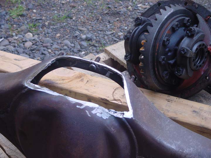 close-up of a differential housing with a cut-out section and a separate differential gear assembly