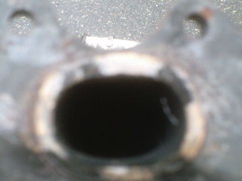 1995 Ford Probe - The opening of a vehicle's exhaust pipe is shown, with visible rust and a website logo at the bottom right.