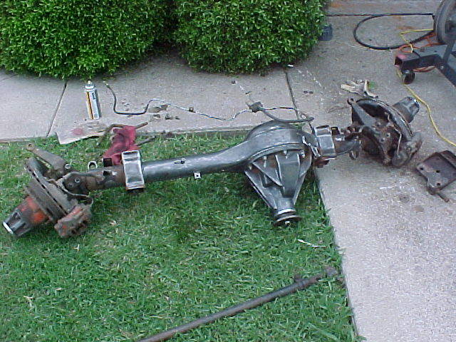 Ford Bronco rear axle assembly on grass and concrete, with brake components visible