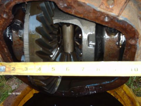 1990 Ford F-150 - A tape measure is placed across the differential gears of a vehicle part.
