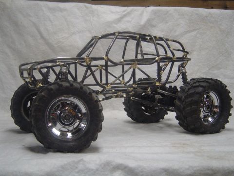 1993 Ford Bronco - This custom-built rock crawler features a prominent tube frame chassis and oversized off-road tires.