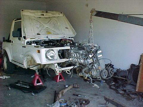1978 Ford Bronco - The engine is suspended by chains as it's removed from the Suzuki Samurai.