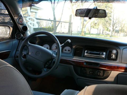 1997 Mercury Grand Marquis - Interior view of a 1997 Mercury Grand Marquis, highlighting the dashboard and driver's area with aftermarket gauges.
