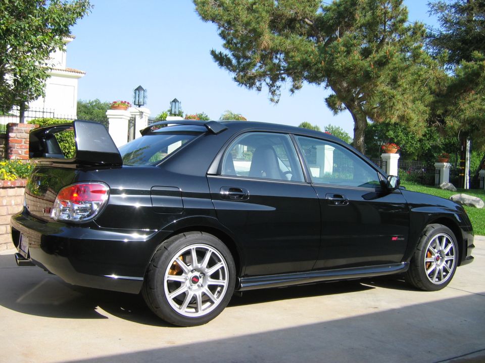 Black 2007 Subaru Impreza WRX STI sedan, rear spoiler, aftermarket wheels