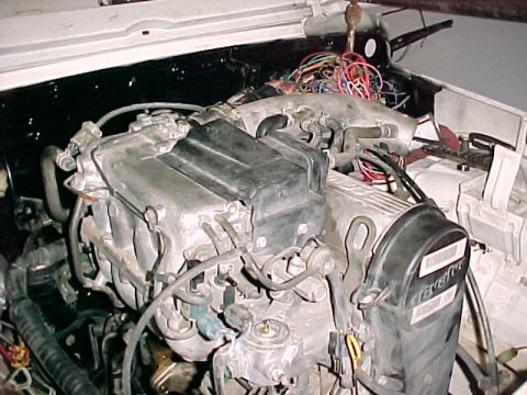 1978 Ford Bronco - Close-up view of an engine bay, showing intricate wiring and mechanical components.