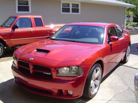 2006 Dodge Charger - Red 2006 Dodge Charger SRT8 with a red pickup truck in the background.