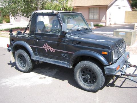 1987 Suzuki Samurai - This black 1987 Suzuki Samurai features a distinctive pink graphic on its side panel.