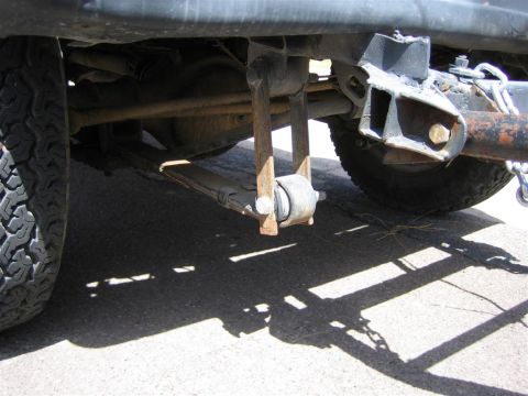 1987 Suzuki Samurai - Rear suspension detail showing leaf springs and a trailer hitch attachment point.