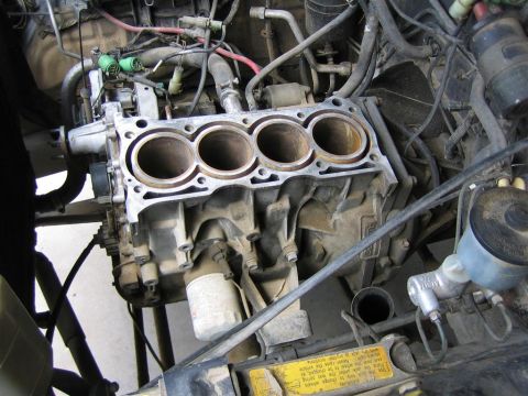 1987 Suzuki Samurai - Close-up view of an engine block, revealing the cylinder bores and associated mechanical parts.