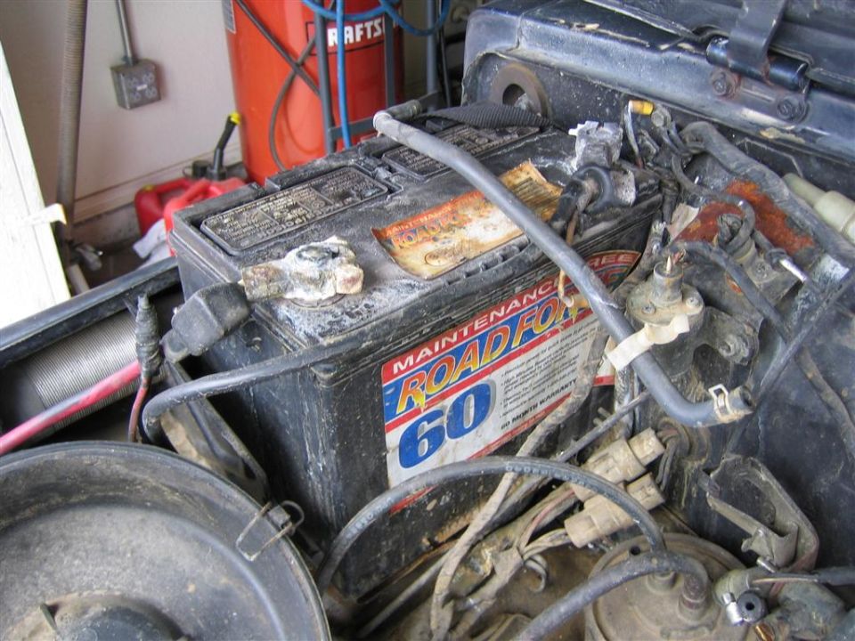 Roadfox 60 car battery with corroded terminals and engine wiring