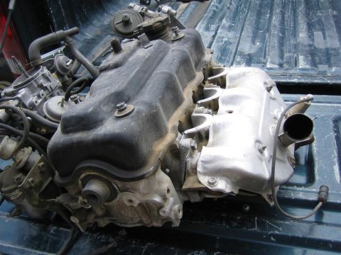 1987 Suzuki Samurai - Engine assembly, likely from a small SUV or truck, is shown in a pickup bed. The registry claims it is from a 1987 Suzuki Samurai.