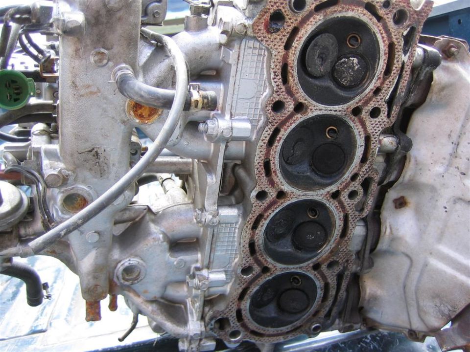 Close-up of an engine cylinder head with four cylinders visible