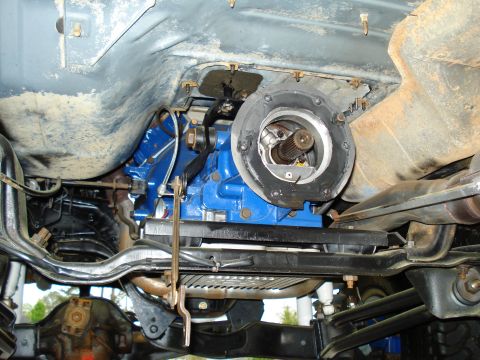 1984 Ford Bronco - Close-up view of the vehicle's transmission and drivetrain, showing the output shaft and surrounding components.