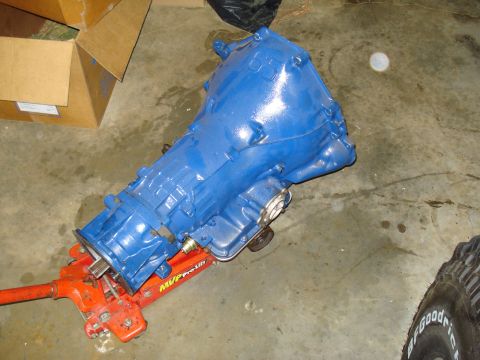1984 Ford Bronco - A blue transmission is shown resting on an orange hydraulic jack, with "MVP Pro-Lift" visible on the jack.