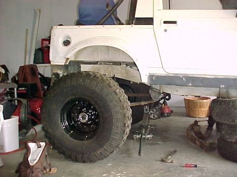 1978 Ford Bronco - The vehicle's chassis is visible with a large tire, suggesting it is a work in progress.