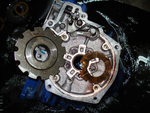 1984 Ford Bronco - Close-up of internal transmission components, including gears and a bearing cage, with visible fluid.
