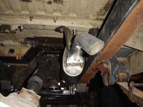 1971 Ford Bronco - Close-up of the exhaust system and drivetrain components underneath a vehicle.